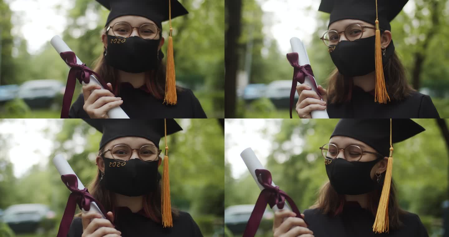 十几岁的女孩穿着毕业礼服和帽子，戴着防护口罩