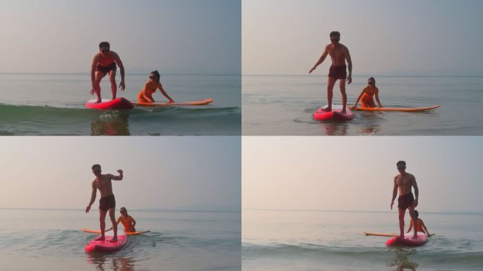 无标题项目一对年轻男女玩冲浪板站起水面