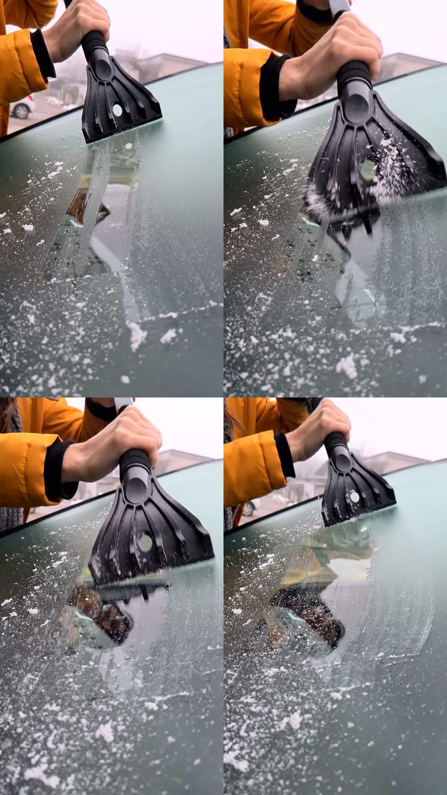 女人用刮刀刮除挡风玻璃上的冰。