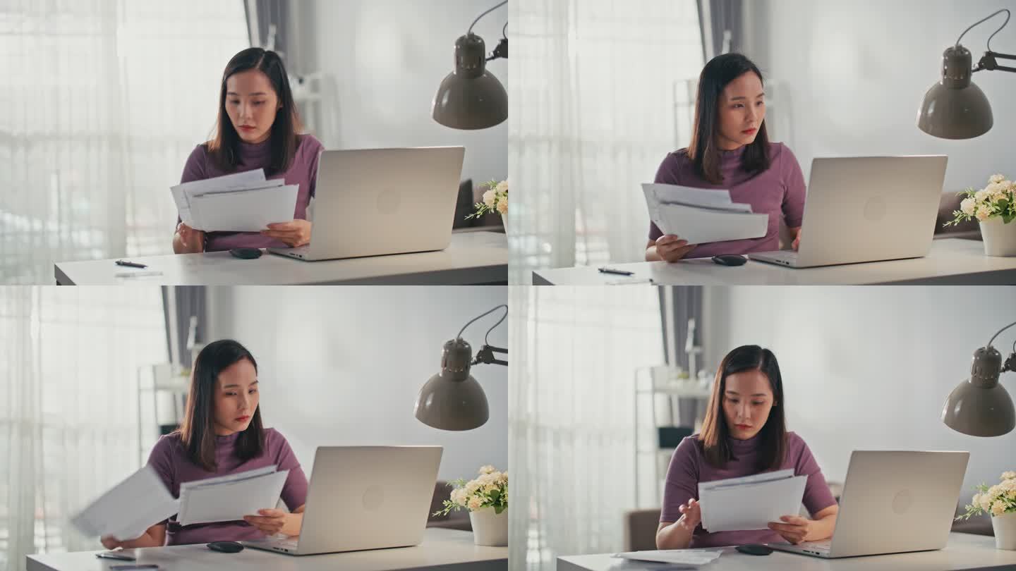 亚洲女性在家里用笔记本电脑在线支付账单