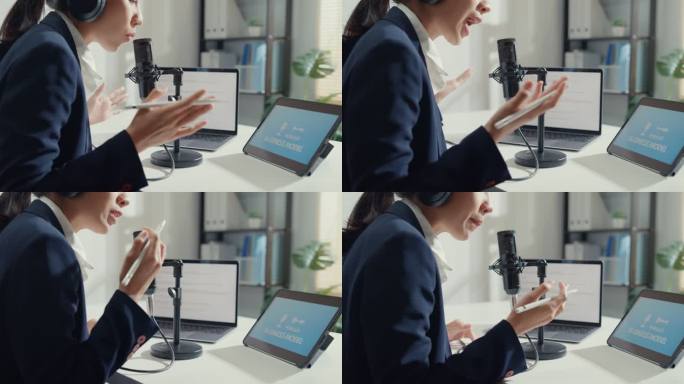 一位年轻的亚洲女商人在工作室办公室用笔记本电脑录制和播放播客的特写镜头。