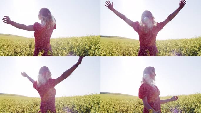 4k视频片段，一名年轻女子在一片油菜花盛开的田里放松