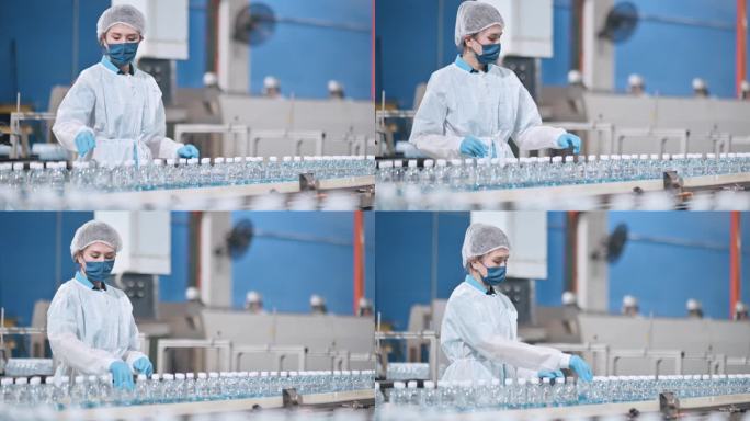 亚裔中国女性饮用水厂生产线工人，带PPE检查水瓶，日常工作