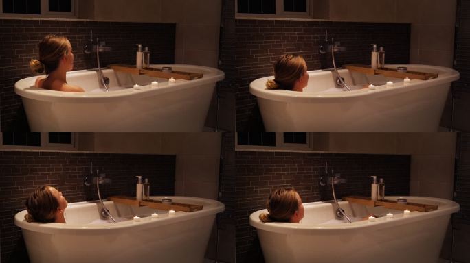 年轻女子沉入浴缸，放松身心