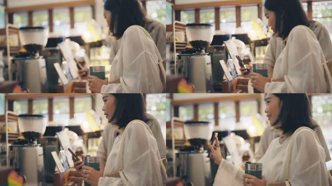 亚洲女性顾客自带咖啡杯购买咖啡。