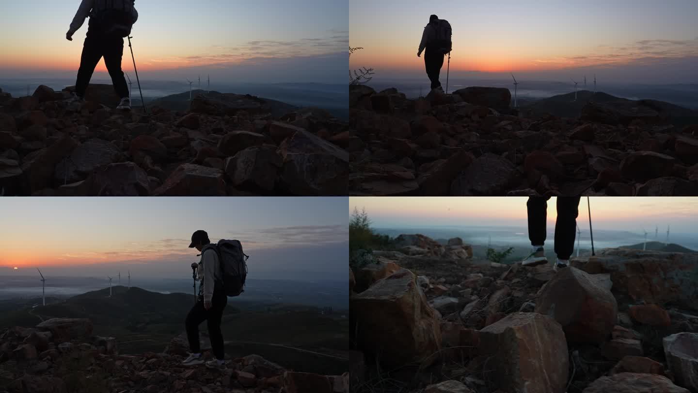 徒步者清晨登上山顶迎接朝阳