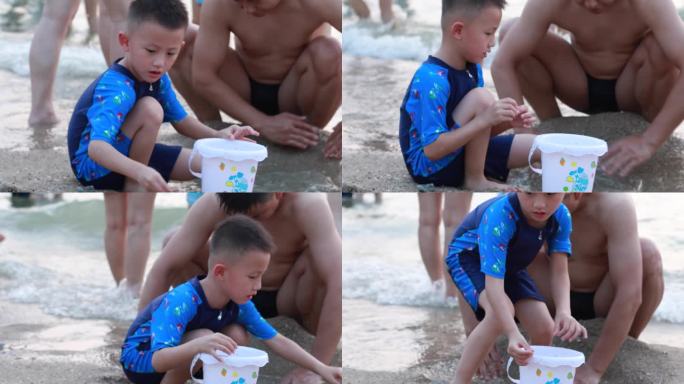 小朋友在海边跟爸爸一起玩沙子
