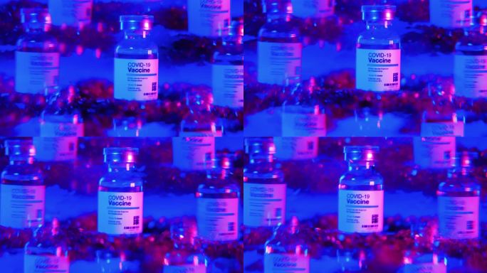 实验室桌子上的科维-19疫苗瓶的错觉，蓝色和粉色光谱闪烁。免疫概念
