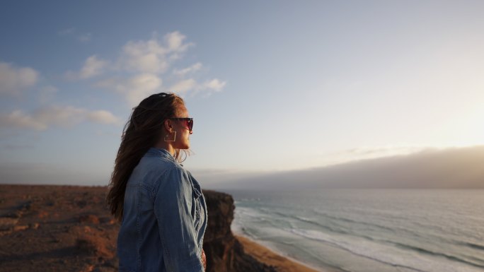 一名女子从悬崖边眺望大海的特写镜头