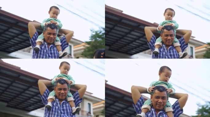 亚洲祖父肩扛着孙子玩耍。