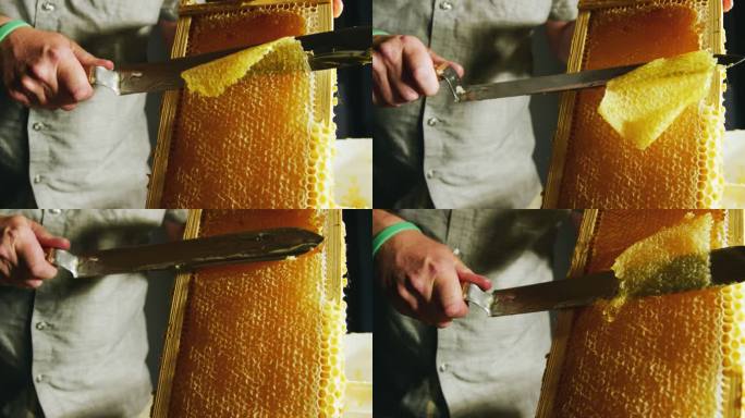 一名白人男子用刀切开蜂巢，将蜂蜡刮到附近的桶中，蜂蜜从木架上滴下