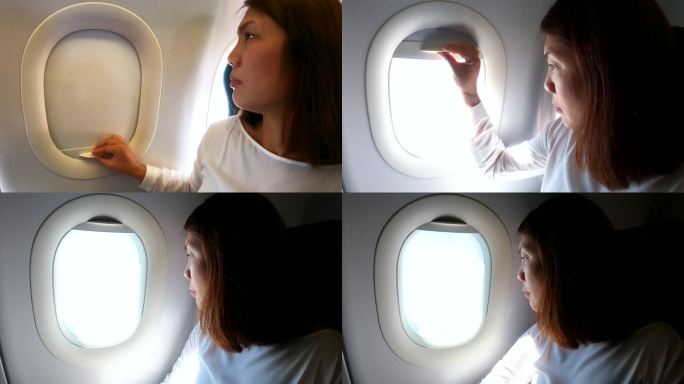 女乘客在飞行过程中打开飞机窗户并向外看