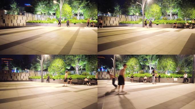 夜晚公园广场玩滑板车的年轻人