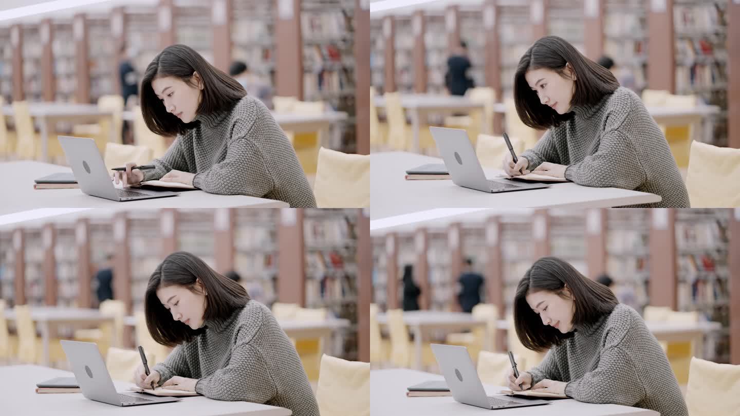 亚洲大学生在图书馆使用笔记本电脑