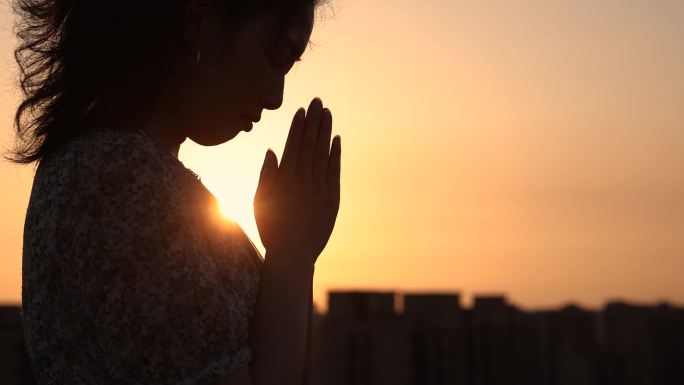 女人在阳光下祈祷女性虔诚教徒心里默念