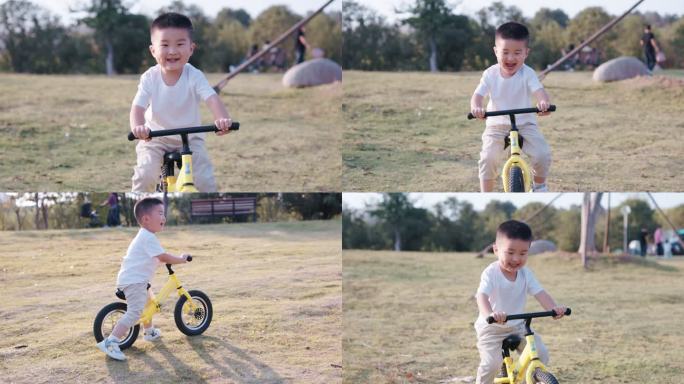 4K夕阳下一个可爱的小男孩在草坪骑平衡车