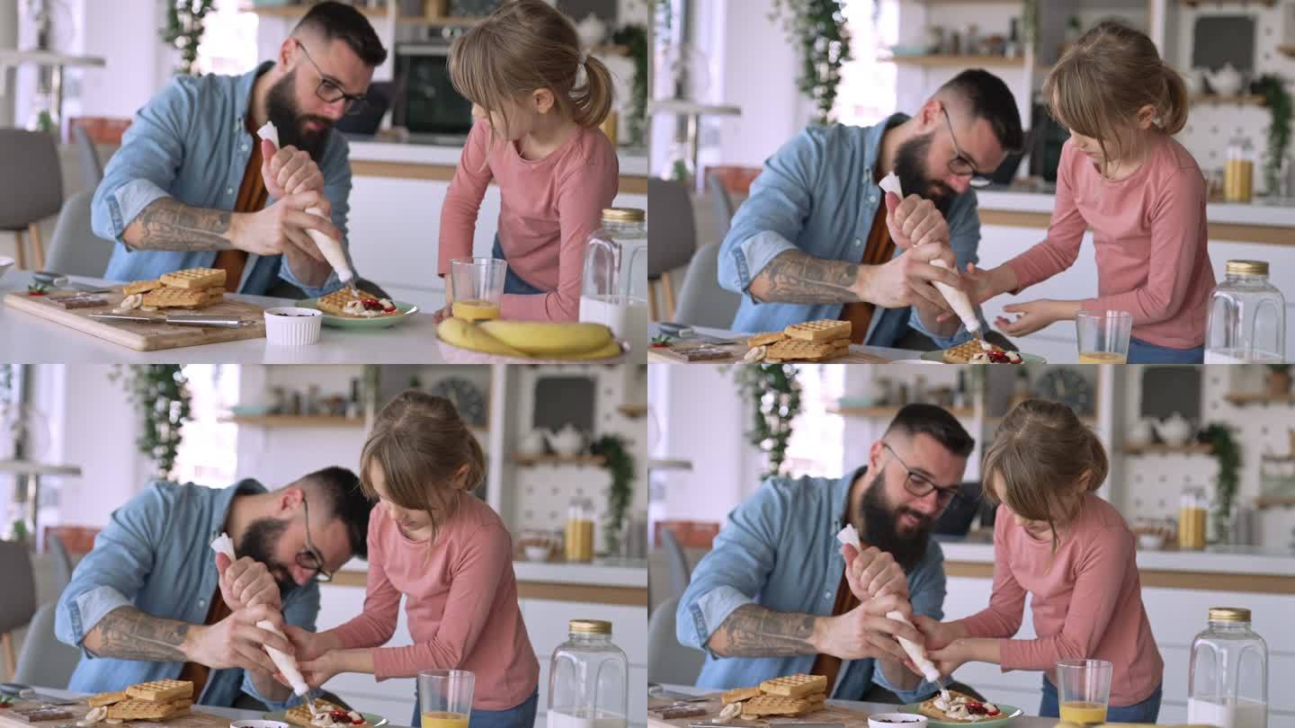 父亲和女儿在厨房装饰华夫饼