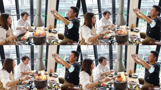 亚洲成人朋友在烧烤餐厅用智能手机拍照和视频点播