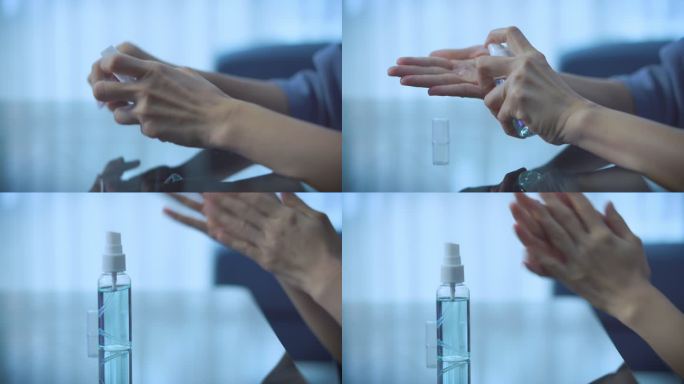女性在使用智能手机时使用喷雾酒精洗手，喷洒消毒液，清除病毒