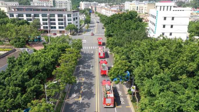 航拍消防车出警在公路上行驶进入工业园区