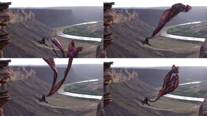 杂技青年女子在犹他州摩押附近的一个峡谷上空的松弛线表演空中丝绸，背景是黄昏时的绿河峡谷