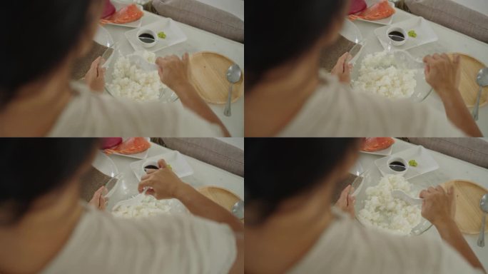 日本裔女厨师为寿司准备米饭