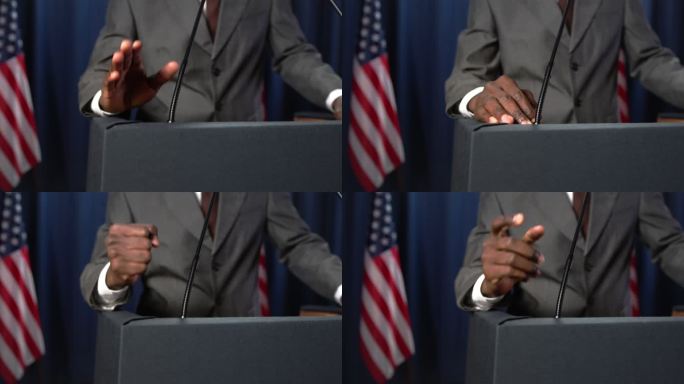 非洲裔美国政治家发表了一篇感人的演讲，做了很多手势，但特写镜头中只有他的拳头