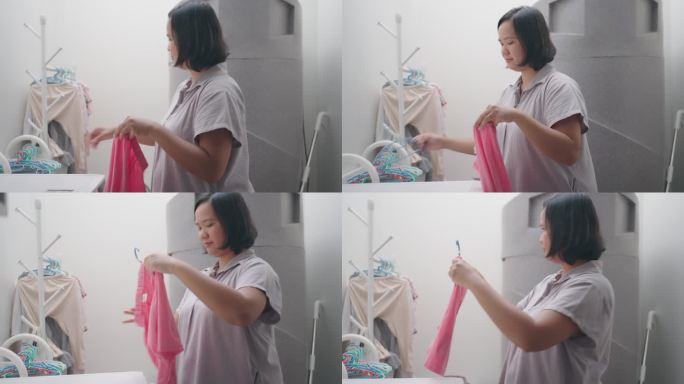 洗完衣服后挂湿衣服的女人