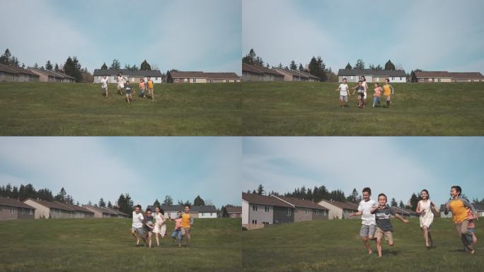 混合种族小学儿童在草地公园跑步和玩耍