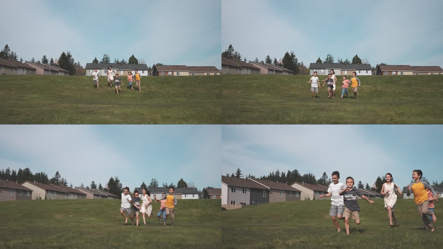 混合种族小学儿童在草地公园跑步和玩耍