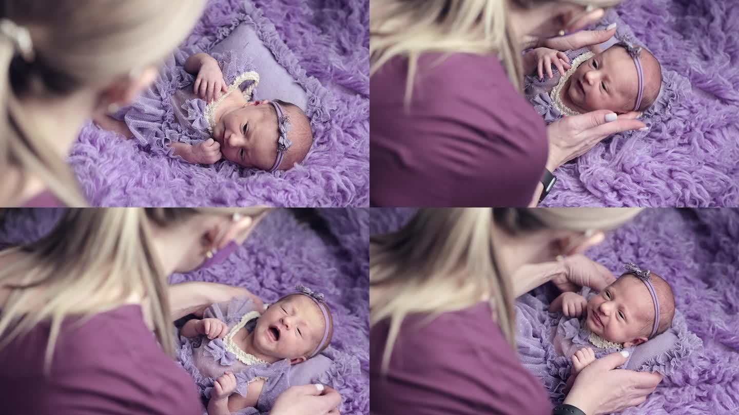 摄影师在拍照时照顾婴儿。婴儿在拍照时打喷嚏。