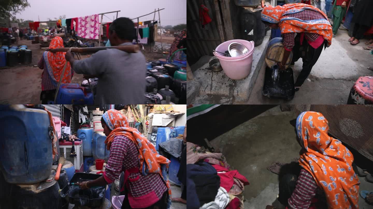 印度德里南部居民拎塑料桶去接水