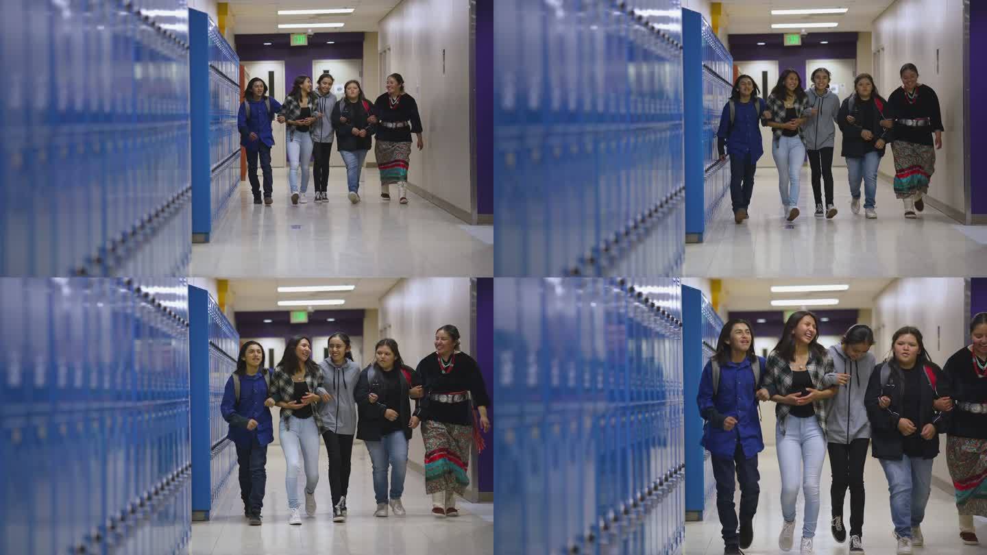 一群学生孩子手挽手穿过学校走廊