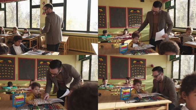 小学一位年轻男老师在课堂上帮助男生