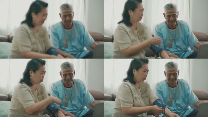 亚洲老年夫妇在家检查血压。