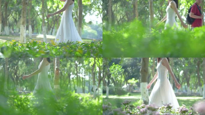 穿白色长裙的女孩在花丛中行走4k视频素材