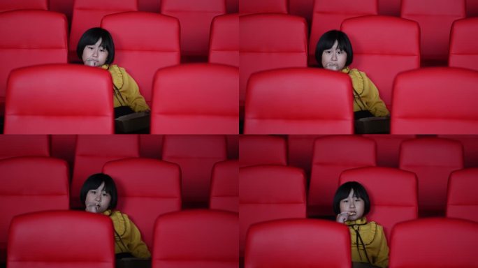 正视亚洲中国年轻女孩一边吃薯条一边独自在电影院看电影