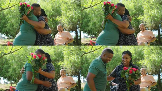 丈夫在夏日公园给妻子送玫瑰花束