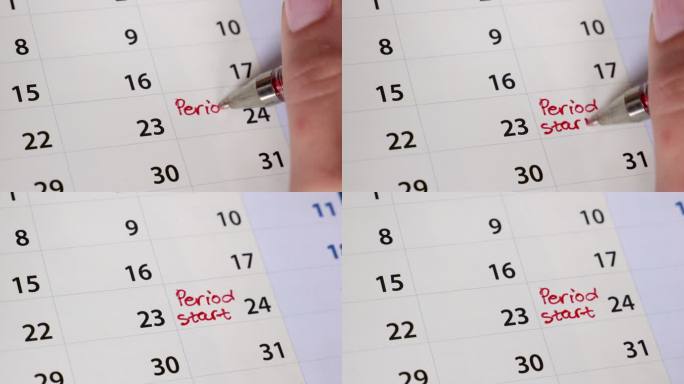 女性用红笔在日历上书写月经提醒