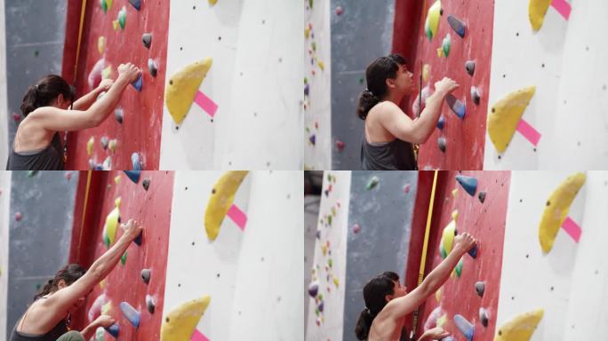 专注于室内攀岩，身体健康的年轻女性，积极主动。在室内攀岩馆安全享受极限运动的运动女性。肾上腺素垃圾夹