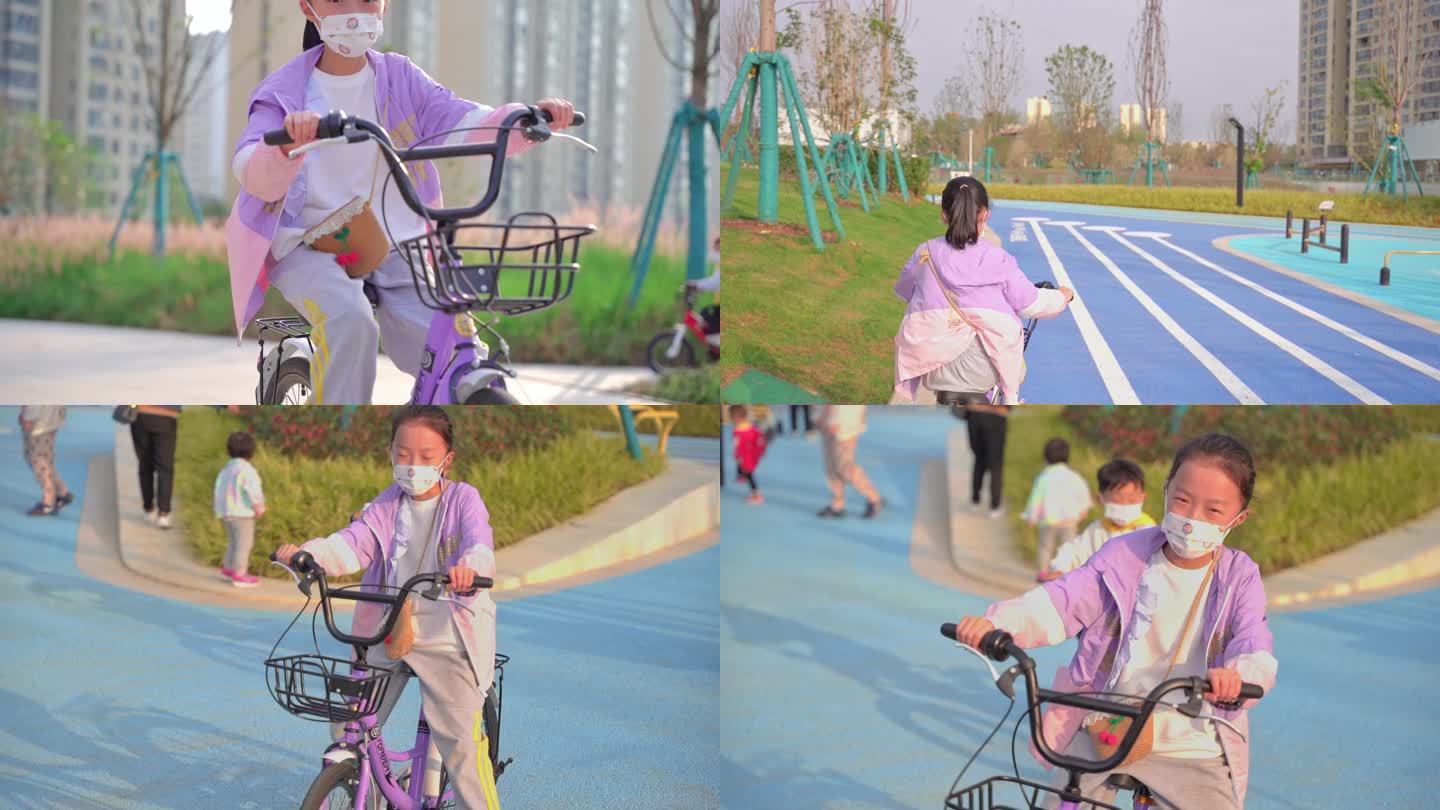 戴着口罩骑自行车的小女孩