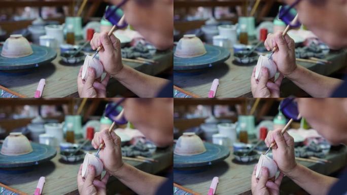 陶艺大师在瓷胚上艺术绘画