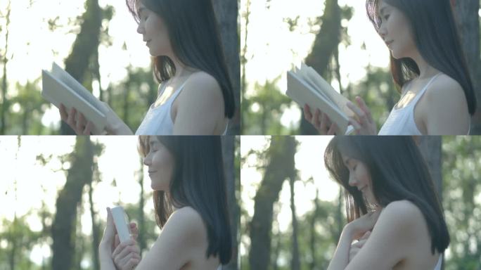 女孩靠在树上看书怀抱书本