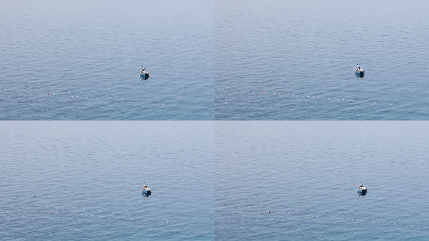 海景，一个渔夫在公海中的一艘小船上。