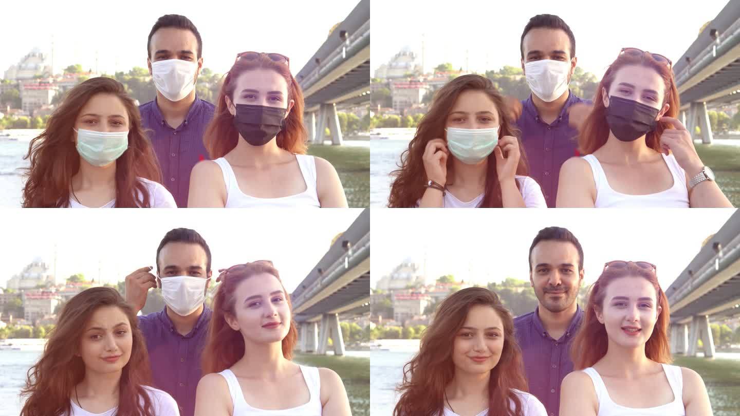 伊斯坦布尔省视频显示，禁闭重新开放后，多种族朋友戴着口罩微笑——新的正常友谊概念，男女朋友在旅游度假