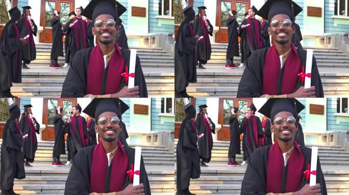 一个身着毕业礼服和迫击炮的男人，手里拿着毕业证书，对着镜头微笑