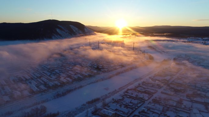 航拍冷空气笼罩森林小镇雪景