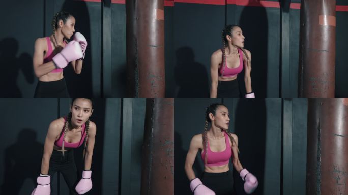 在拳击比赛中，亚洲年轻女子在拳击袋上锻炼。