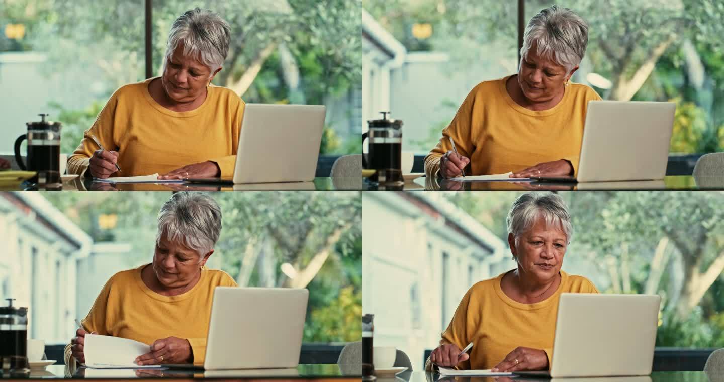 一名老年女性使用笔记本电脑并在家里完成文书工作的4k视频片段