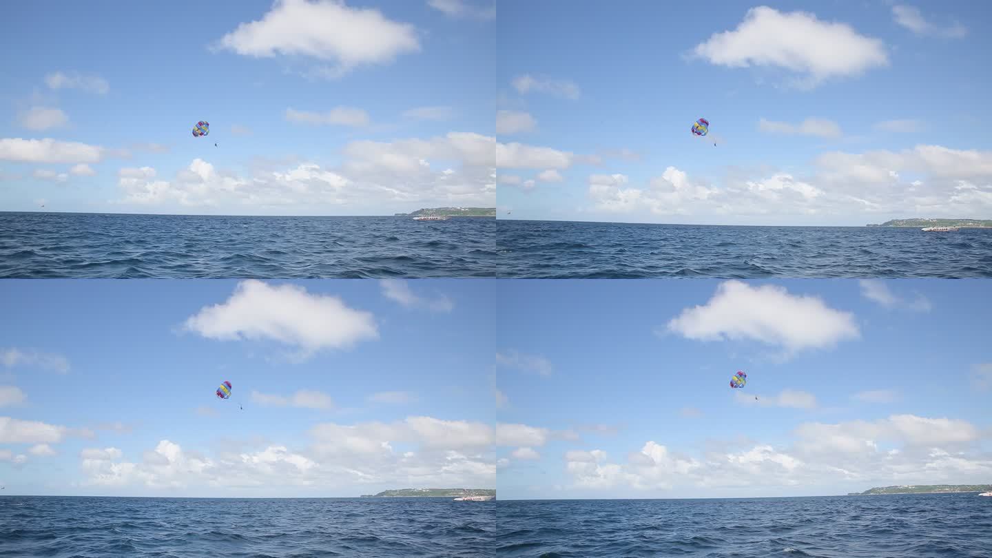 海上的彩色拖伞漂浮在蓝天中